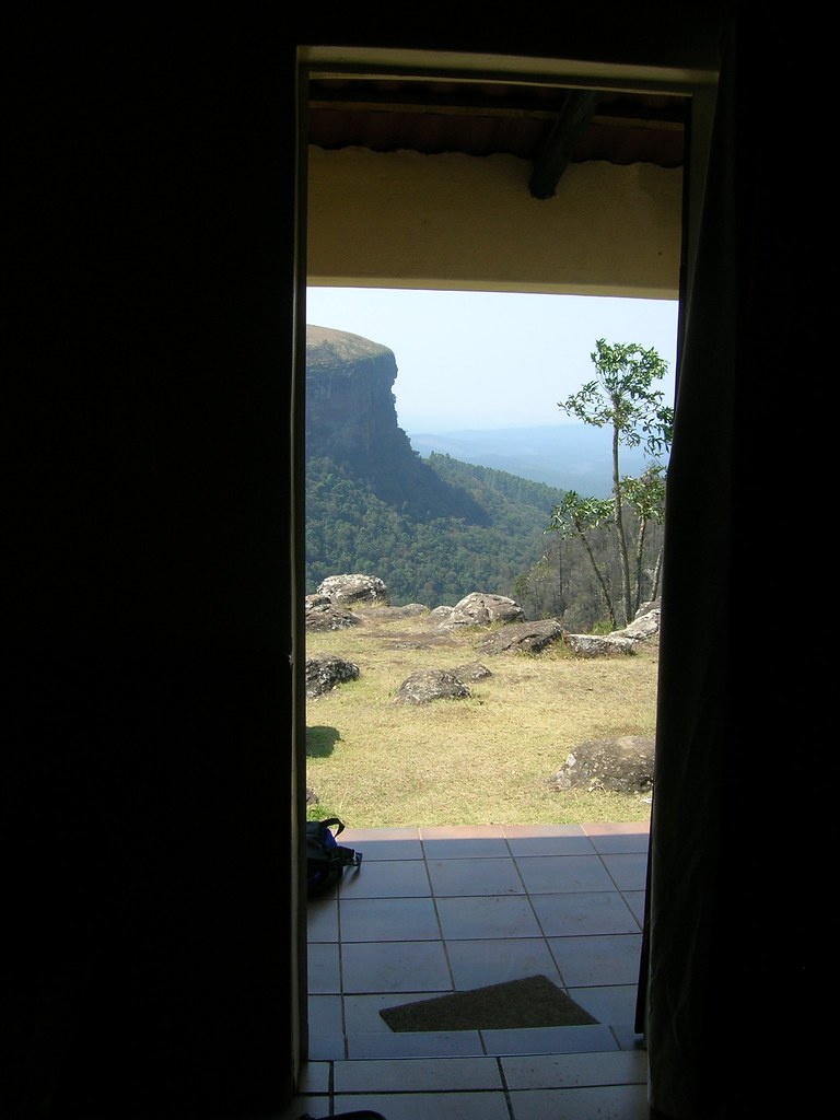 Looking out from a front door to with a forested 300 foot high cliff in the mid-distance